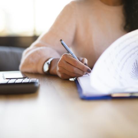 Woman writing on paper
