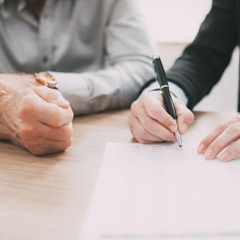Couple signing legal paperwork.